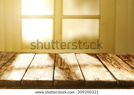 blurred background of window and sun light of morning sun with table of brown color