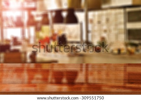 blurred background of kitchen room with red flare and dark glasses red desk