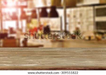 blurred background of kitchen room with red flare and gray wooden desk space