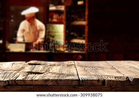 black background of cook in restaurant and restaurant table and wooden top