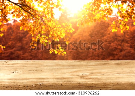 wooden desk top and autumn leaves