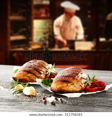young cook in kitchen interior of bar and black space and duck meat