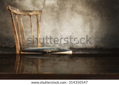 gray old worn wall in interior with retro chair and black desk top of wood space