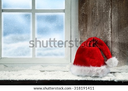 Christmas baubles on snow and window