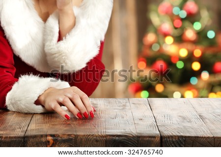 blurred background of xmas tree in home and table and woman