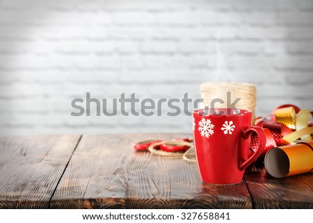 wooden board place xmas time and red mug of hot tea