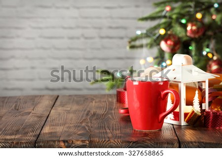 wooden desk space red mug and xmas tree