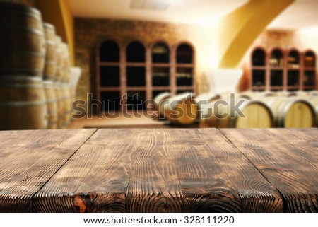 brown dark interior with barrels of wine and desk space and space for your glass
