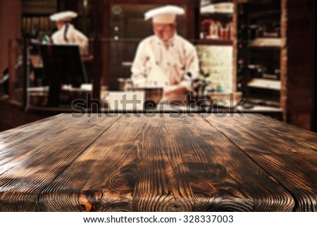 cook and big brown table of wood