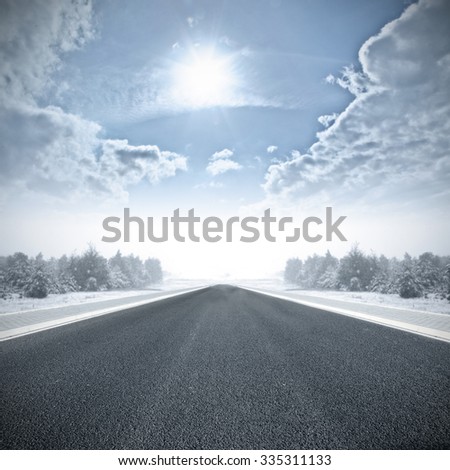 road and sun on blue sky