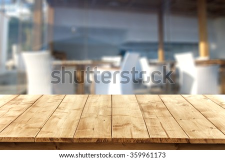 blurred background of beach bar at summer time with yellow wooden desk