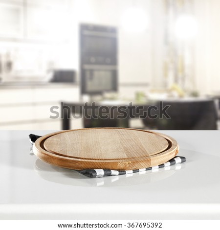 blurred background of kitchen interior and shelf and wooden kitchen desk space and blue and white napkin