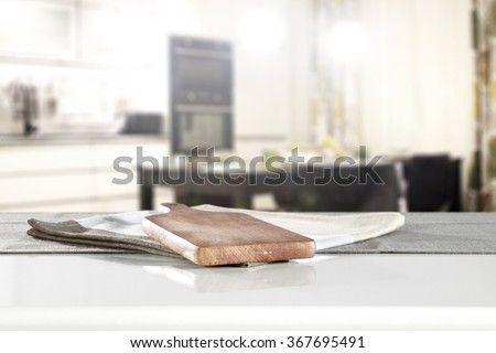 blurred background of kitchen interior and board of kitchen table and kitchen desk on napkin