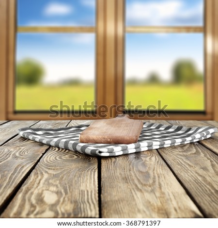 blurred background of brown wooden window space and free space for your food on napkin and kitchen desk
