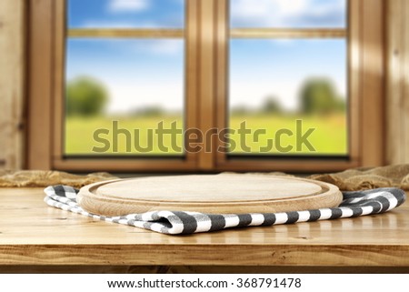 blurred background of brown wooden window space and desk napkin and window sill