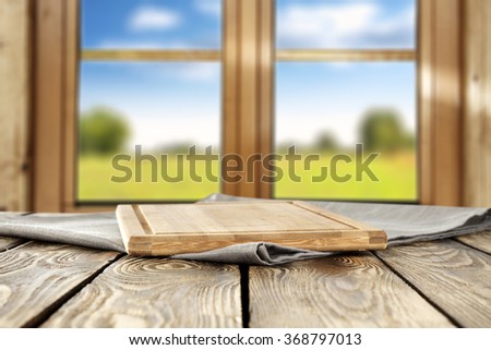 spring wooden window space in blurred background and free space for you on wooden kitchen desk and napkin