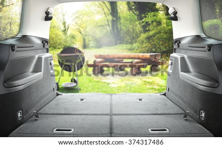 interior of open car trunk and garden and grill