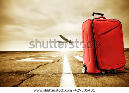 retro photo of sunset time and golden hour with red big bag on road and plane