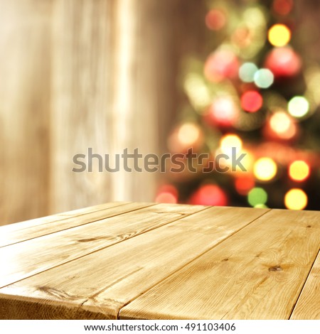interior with blurred xmas tree and wooden old table place