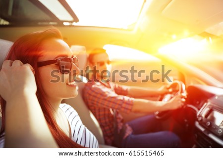 Woman and men in car and summer trip