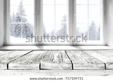white winter window with a wooden table and a place for an advertising product