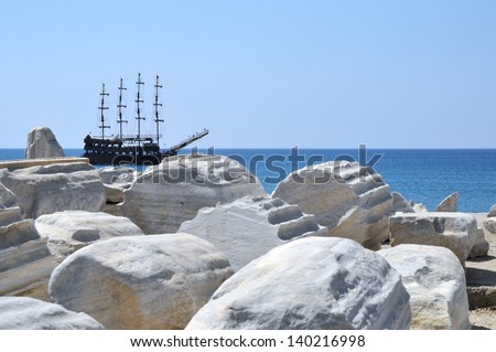 pirate ship in front of a sunny day side