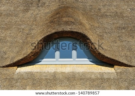 thatched roof with rounded window