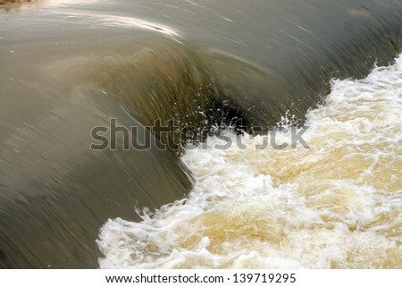 Dirty water flows close up photo