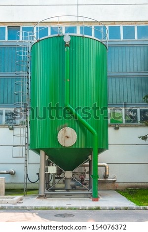 Modern fluid tank outdoors in green color