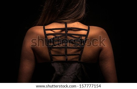 Back of a woman in the dark