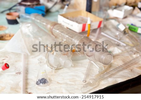 old laboratory with a lot of bottles and dirt
