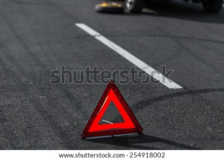 Red triangle of a car on the road