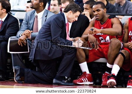 GLENDALE, AZ - DECEMBER 20: Coach Rick Pitino of the Louisville Cardinals outlines a play for Samardo Samuels #24 in the basketball game against Minnesota on December 20, 2008 in Glendale, Arizona.