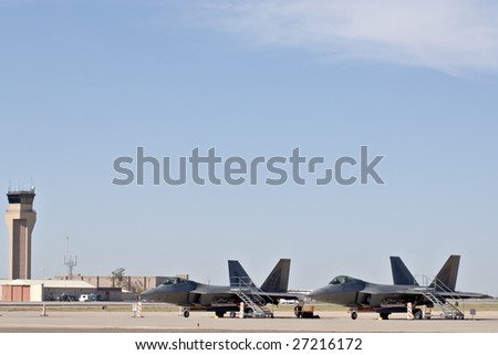 GLENDALE, AZ - MARCH 21: Two U.S. Air Force F-22 Raptor fighters parked on the runway at the biennial air show (\