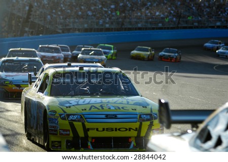 AVONDALE, AZ - APRIL 18: Carl Edwards #99 in the middle of a group of cars at the NASCAR Sprint Cup race at the Phoenix International Raceway on April 18, 2009 in Avondale, AZ.