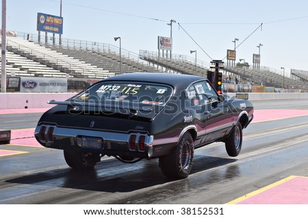 CHANDLER, AZ - OCTOBER 1: A hot rod car pops a wheelie at the start of the race at the NHRA Pacific Division drag racing championship on October 1, 2009 in Chandler, Arizona.