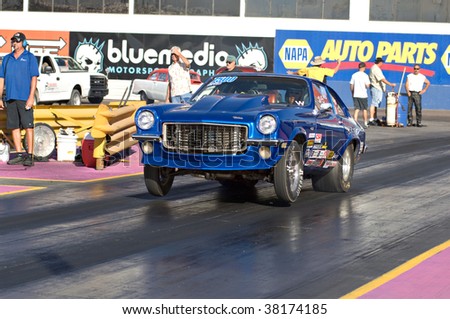 CHANDLER, AZ - OCTOBER 2: A hot rod car pops a wheelie at the start of the race at the NHRA Pacific Division drag racing championship on October 2, 2009 in Chandler, Arizona.