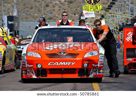 AVONDALE, AZ - APRIL 10: The pit crew pushes the #20 Home Depot Toyota car, driven by Joey Logano, onto the track before the start of the Subway Fresh Fit 600 on April 10, 2010 in Avondale, AZ.