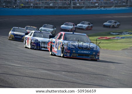 AVONDALE, AZ - APRIL 10: Max Papis (#13) leads a group of cars out of turn one at the Subway Fresh Fit 600 NASCAR Sprint Cup race on April 10, 2010 in Avondale, AZ.