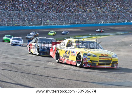 AVONDALE, AZ - APRIL 10: Clint Bowyer (#33) leads a group of cars out of turn one at the Subway Fresh Fit 600 NASCAR Sprint Cup race on April 10, 2010 in Avondale, AZ.