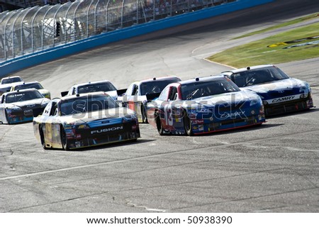 AVONDALE, AZ - APRIL 10: A group of cars comes out of turn two at the Subway Fresh Fit 600 NASCAR Sprint Cup race on April 10, 2010 in Avondale, AZ.