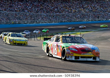 AVONDALE, AZ - APRIL 10: Kyle Busch (#18) leads a group of cars out of turn two at the Subway Fresh Fit 600 NASCAR Sprint Cup race on April 10, 2010 in Avondale, AZ.