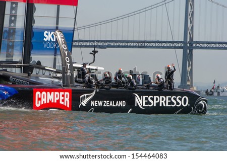 SAN FRANCISCO, CA - SEPTEMBER 12: The crew of Emirates Team New Zealand waves to the crowd after winning their America\'s Cup race in San Francisco, CA on September 12, 2013