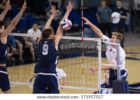 IRVINE, CA - JANUARY 17: Travis Woloson of UCI spikes the ball in a volleyball match with Brigham Young University at the Bren Events Center in Irvine, CA on January 17, 2014