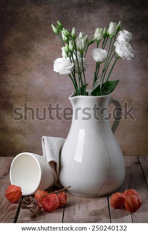 eustoma in old vase on table