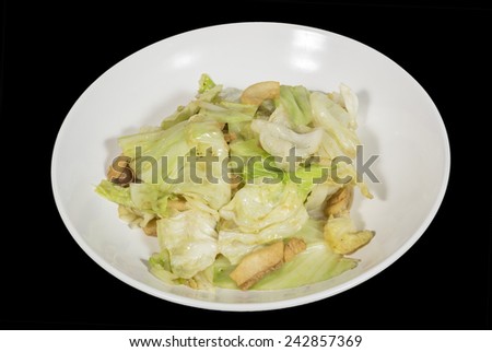 stir-fried cabbage with fish sauce in the plate isolated on black