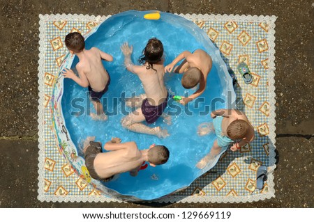 Children in a colorful kiddie pool.