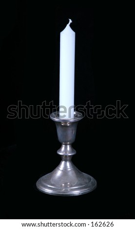 white candle in silver candelstick