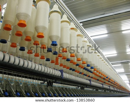 Array of cotton yarn spools (bobbins) in a textile factory