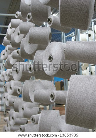 Array of cotton yarn spools (bobbins) in a textile factory